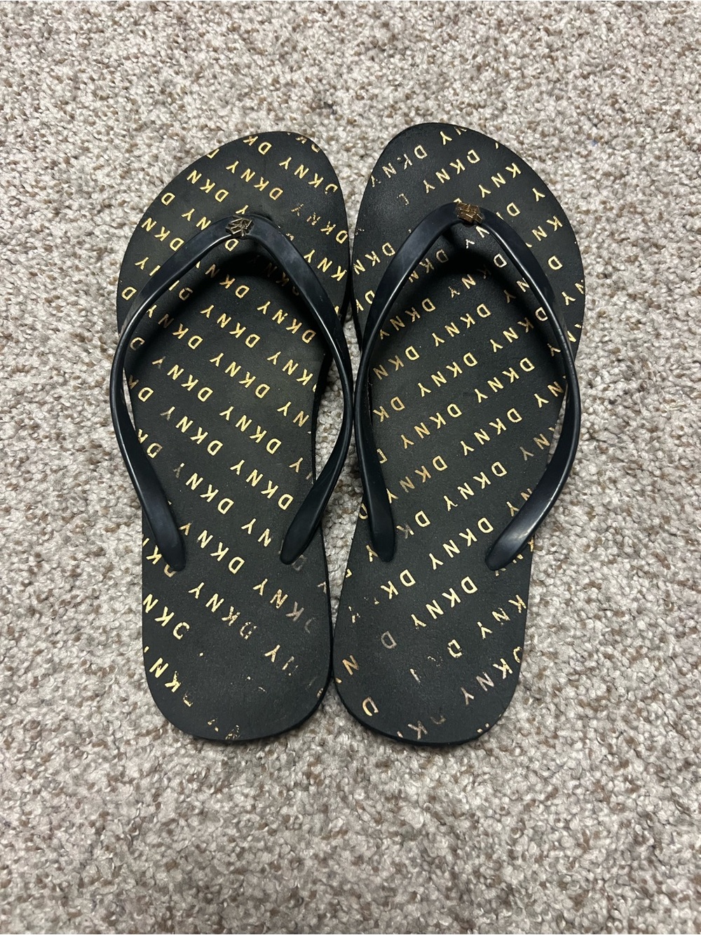 DKNY Black Flip Flops with Gold Logo Pattern